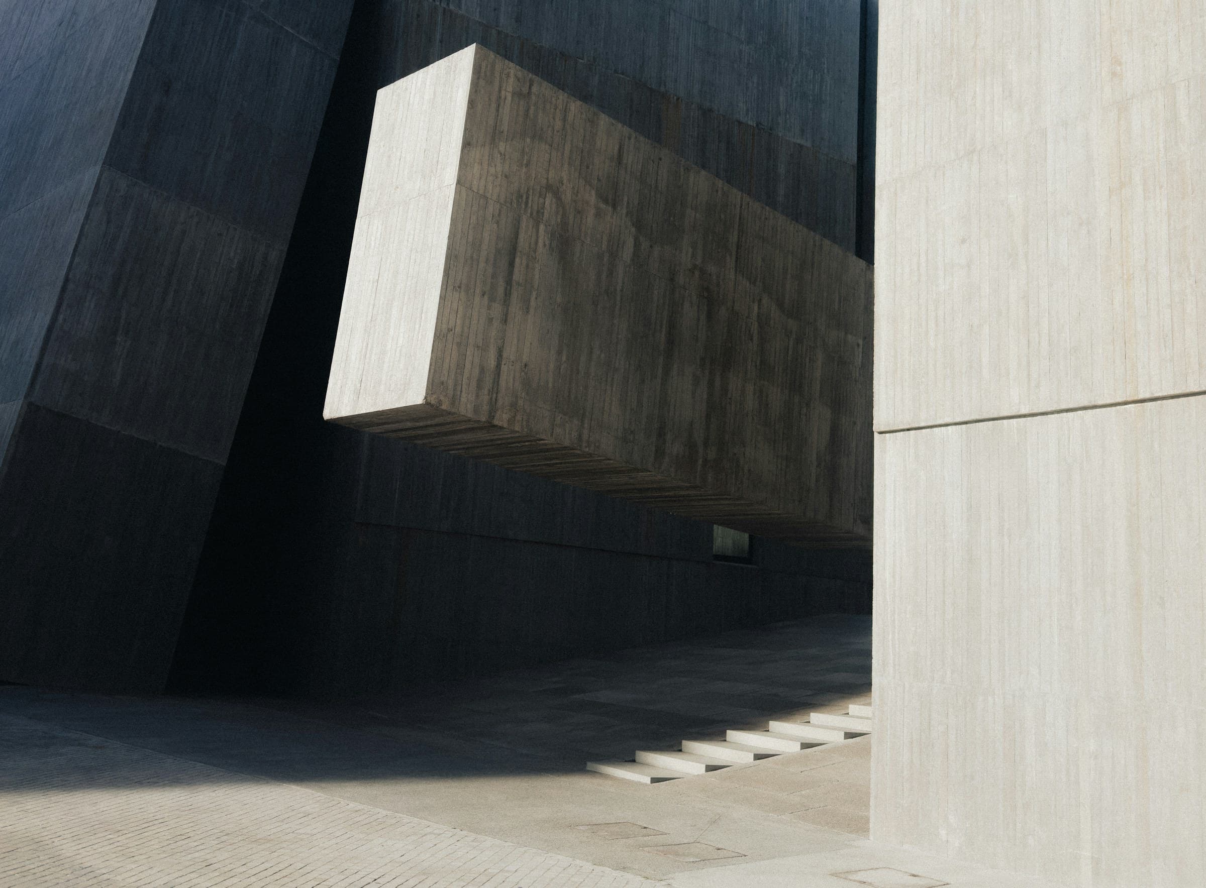 Modern concrete architecture with geometric forms and deep shadows